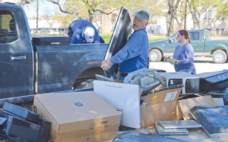 (THE GRAHAM LEADER | ARCHIVE PHOTO) Keep Graham Beautiful and volunteers help unload electronics on the Graham downtown square during the annual Spring Clean-Up event in 2023. The event this year will kick off Saturday, April 6.