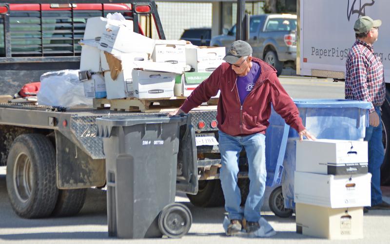 (THE GRAHAM LEADER | ARCHIVE PHOTO) Brad Partridge volunteers and assists with paper shredding at the Paper Pig truck during the kickoff event for the Spring Clean-Up event in March 2023. The event this year will be held from Saturday, April 6 through Sunday, April 14.