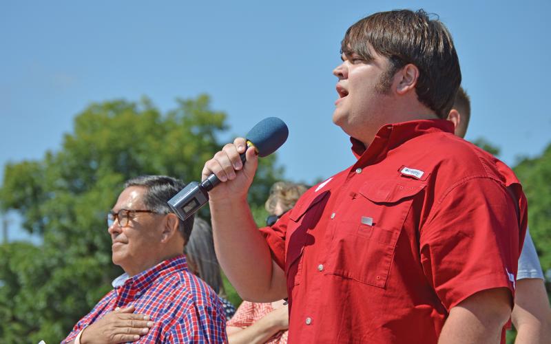 (THE GRAHAM LEADER | ARCHIVE PHOTO) Race Ricketts sings the National Anthem to start off the Independence Day Parade on the Graham downtown square in 2017.