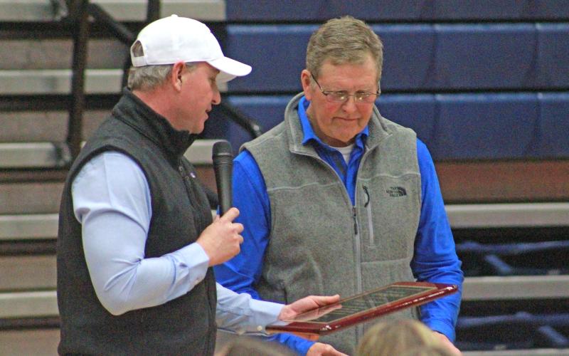 (TC GORDON | THE GRAHAM LEADER) Darby Brockway (left) of the Graham Athletic Booster Club presents an award to Kenny Davidson (right), who is retiring as head football coach and athletic director at the end of the 2023-2024 school year.