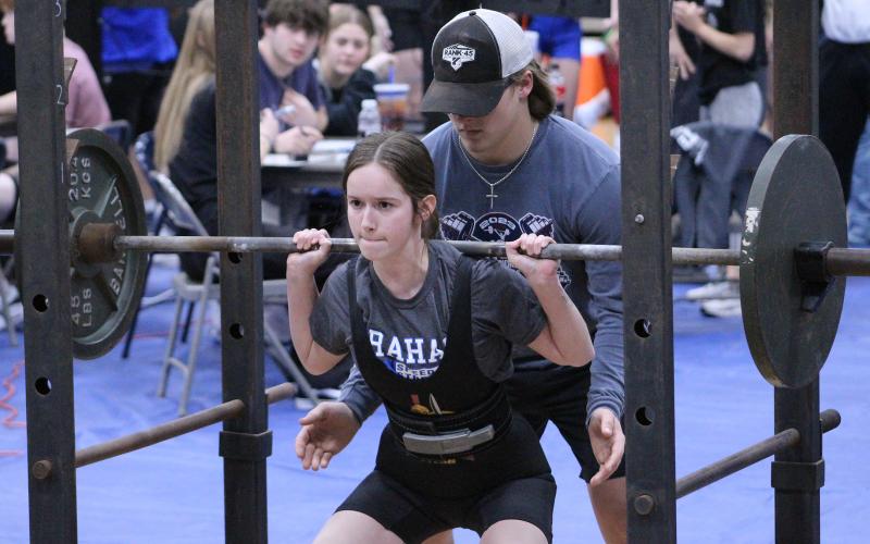 (TC GORDON | THE GRAHAM LEADER) Hannah Hollingsworth performs her squat lift, one of three lifts completed, during a powerlifting competition in Weatherford last Thursday, Jan. 18.