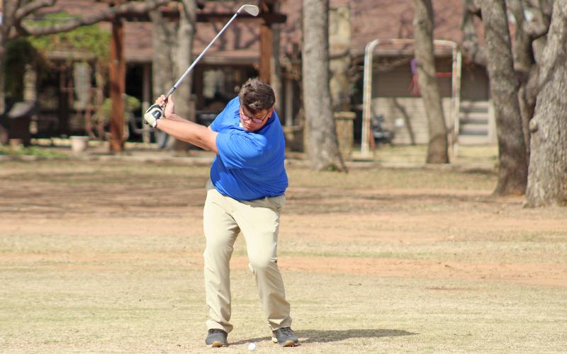 (TC GORDON | THE GRAHAM LEADER) Graham’s Lawson Marin begins his shot looking to make it onto the green during an invitational Monday, Feb. 26 hosted at the Graham Country Club. The Steers’ top team finished fourth in the event.