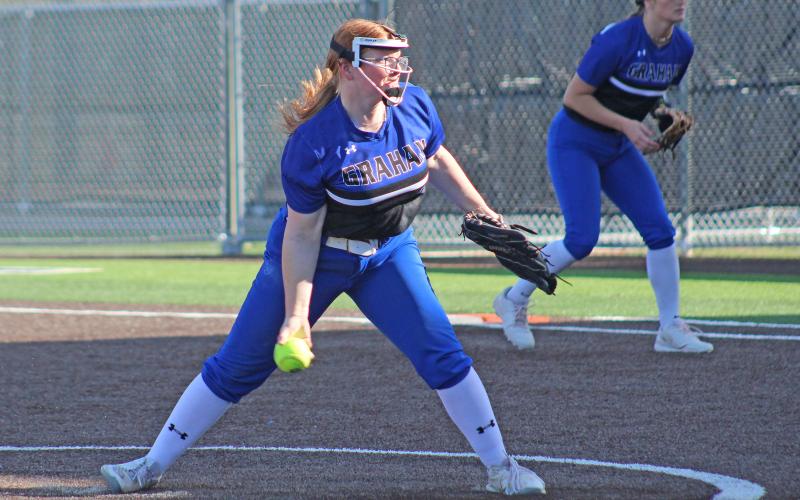 (TC GORDON | THE GRAHAM LEADER) Graham’s Reese Calhoun winds up and releases a pitch during one of the team’s games earlier this season. Calhoun pitched a great game but ran into trouble in the final inning at Stephenville as the Lady Blues took a 5-4 loss in their district opener.