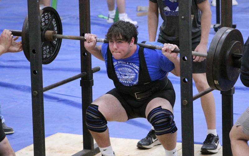 (TC GORDON | THE GRAHAM LEADER) Reese McCrae hits the bottom of his lift and works the weight back up during Graham’s powerlifting event in Weatherford last Thursday, Jan. 18.