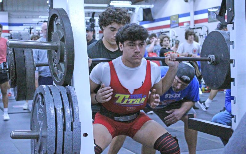 (TC GORDON | THE GRAHAM LEADER) Graham’s Mateo Rodriguez executes one of his squat lifts during the powerlifting competition the Steers hosted last Thursday, Feb. 8. The squat lift is one of three lifts athletes completed during the event.