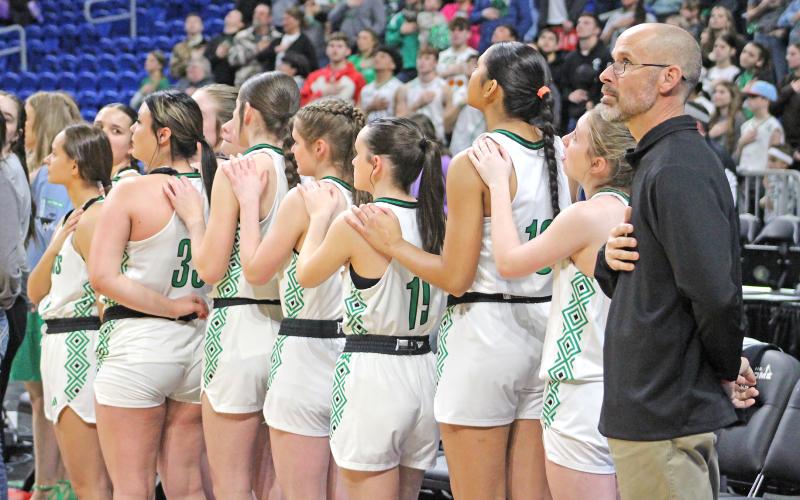 (TC GORDON | THE GRAHAM LEADER) The Newcastle Ladycats stand for the national anthem before their semifinal game against Westbrook. The Ladycats won 59-37 and advanced to the state title game.