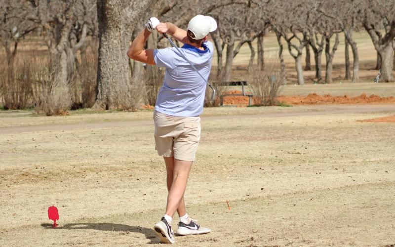 (TC GORDON | THE GRAHAM LEADER) Graham’s Riley Lanham drives a shot from the tee box near the end of his round during an invitational event Monday, Feb. 26 hosted at the Graham Country Club.