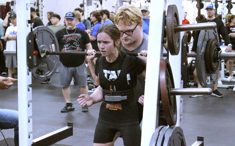 (TC GORDON | THE GRAHAM LEADER) Graham’s Hannah Hollingsworth finishes her squat lift during a competition earlier this season. Hollingsworth qualified for the regional powerlifting meet and sits fourth in her weight class, with the top 12 making it to regionals.