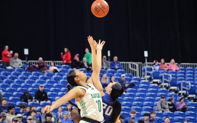 (TC GORDON | THE GRAHAM LEADER) Senior Mya Cabrera wins the opening tipoff for Newcastle in their state semifinal game against Westbrook.