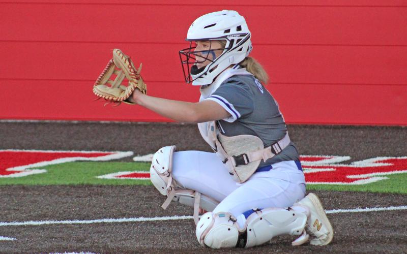 (TC GORDON | THE GRAHAM LEADER) Graham catcher Meagan Brooks sets herself up and prepares to receive a warmup pitch during the Lady Blues’ 12-0 district win over Mineral Wells this past Tuesday, April 2.
