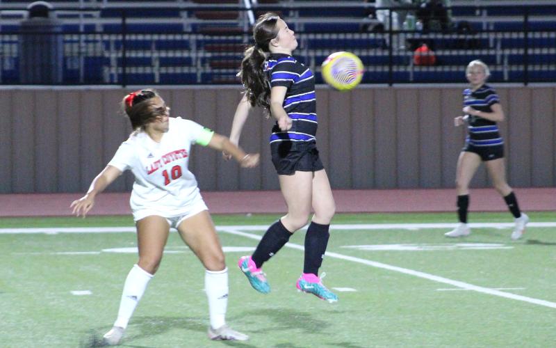 (TC GORDON | THE GRAHAM LEADER) Graham’s Kinsley Amburn uses her body to win possession of the ball during the Lady Blues’ district game against Old High last Friday, Feb. 9. The Lady Blues took a 4-1 loss to the Lady Coyotes.
