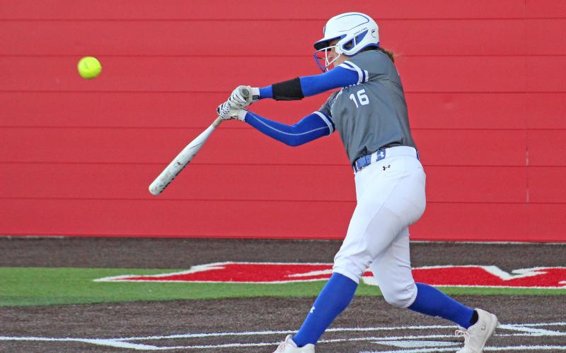 (TC GORDON | THE GRAHAM LEADER) The Lady Blues’ first baseman Peyton Dobbs connects with a pitch for a big hit during Graham’s district contest against Mineral Wells this past Tuesday, April 2. The Lady Blues dominated the visiting Lady Rams 12-0.