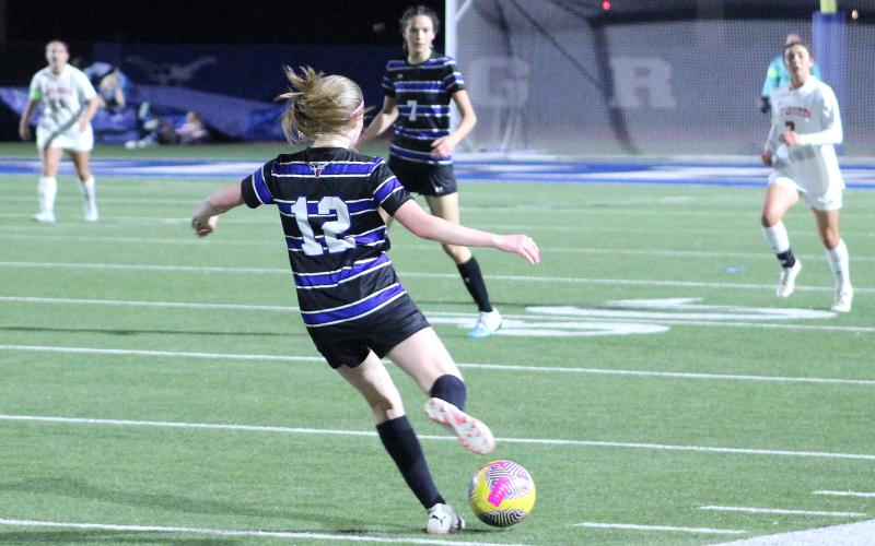 (TC GORDON | THE GRAHAM LEADER) Graham’s Jensen Pettus (12) sends a kick up the length of the field to get it to the offensive players during the Lady Blues’ 4-1 loss to the Old High Lady Coyotes last Friday, Feb. 9.
