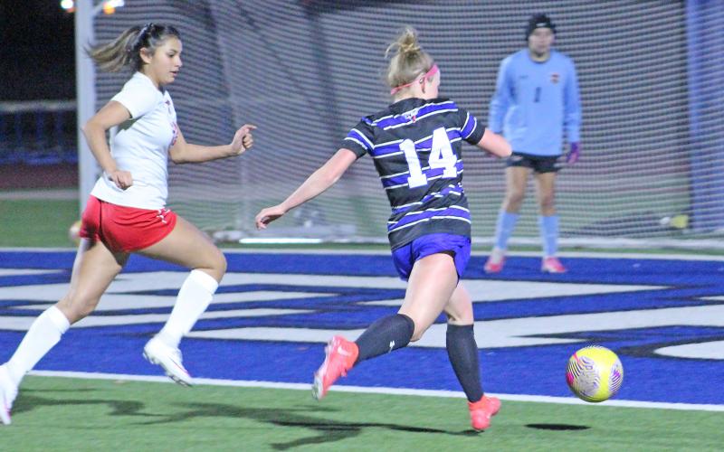(TC GORDON | THE GRAHAM LEADER) Graham junior Olivia Pettus takes a shot on goal from the right side during the team’s district-opening win over Mineral Wells this past Monday, Feb. 5. The Lady Blues defeated the Lady Rams 4-0.