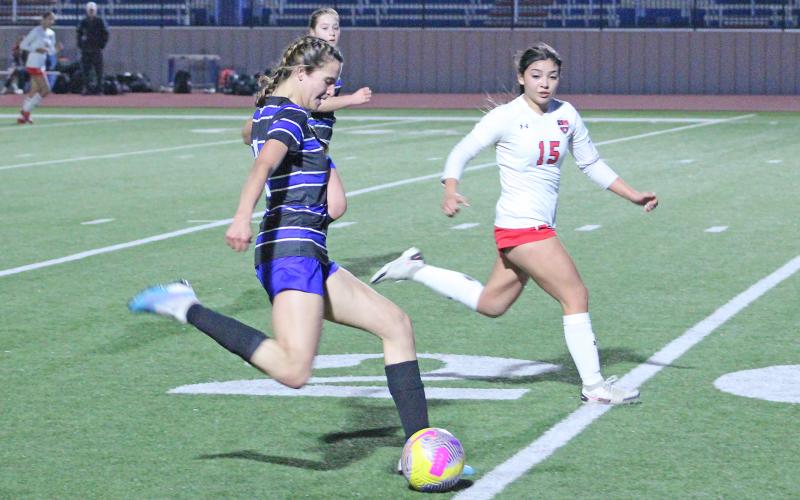 (TC GORDON | THE GRAHAM LEADER) Graham senior Sophie Schlieper takes a deep shot during the team’s district-opening game against Mineral Wells. The Lady Blues earned a 4-0 win Monday, Feb. 5 over the Lady Rams.