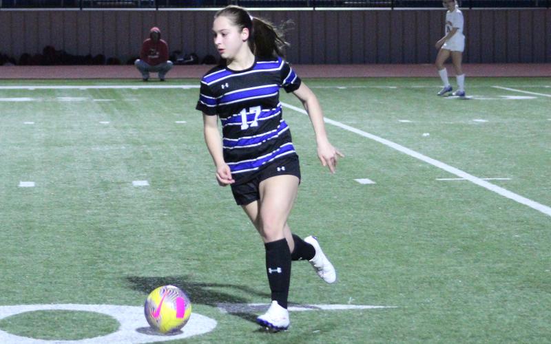 (TC GORDON | THE GRAHAM LEADER) Graham’s Adi Pinkston (17) brings the ball up the field and looks for a teammate to pass to during the Lady Blues’ 4-1 loss to Old High last Friday, Feb. 9.
