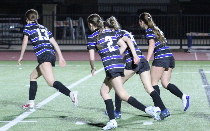 (TC GORDON | THE GRAHAM LEADER) The Lady Blues begin running their play for a corner kick during one of the team’s district games earlier this season. Graham defeated Hirschi 10-0 this past Monday, Feb. 12 in an offensive outburst.