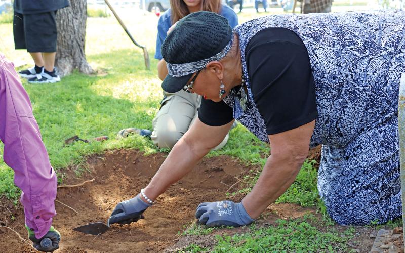(THOMAS WALLNER | THE GRAHAM LEADER) Rev. Vanessa Sims assists researchers from Texas Tech who were at the Oak Grove Colored-William P. Johnston Memorial Cemetery. Sims is a descendant of one of those buried in the cemetery and brought the issue of the cemetery to light.
