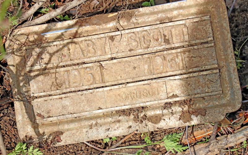 (THOMAS WALLNER | THE GRAHAM LEADER) A grave marker that was uncovered near the fence line in the Oak Grove Colored-William P. Johnston Memorial Cemetery by a member of the Texas Tech research team Saturday, March 23. The marker reads ‘Baby Scott, 1961-1961.'