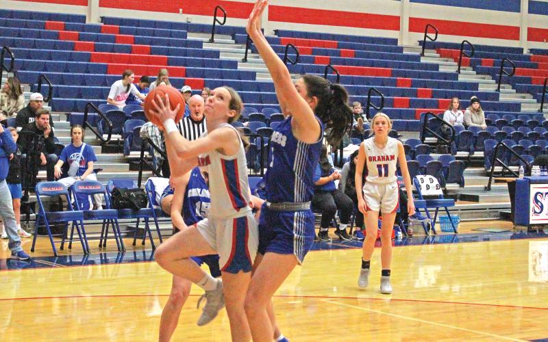 (TC GORDON | THE GRAHAM LEADER) Graham’s Hannah Williams scored the team’s first four points of the game which included this layup past a Childress defender. The Lady Blues fought hard but struggled in their first game back from break, taking a 47-21 loss.