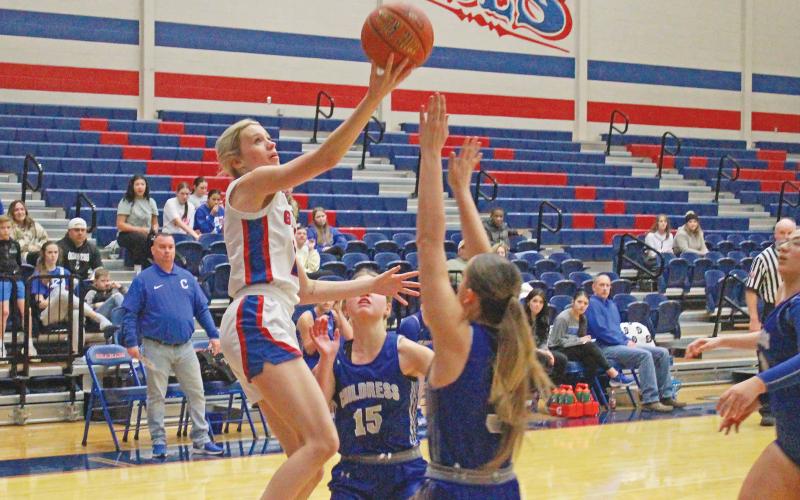 (TC GORDON | THE GRAHAM LEADER) Senior guard Maddie Franklin attempts a layup over two Childress defenders during the Lady Blues’ 47-21 loss Thursday, Dec. 28 to the Lady Bobcats.