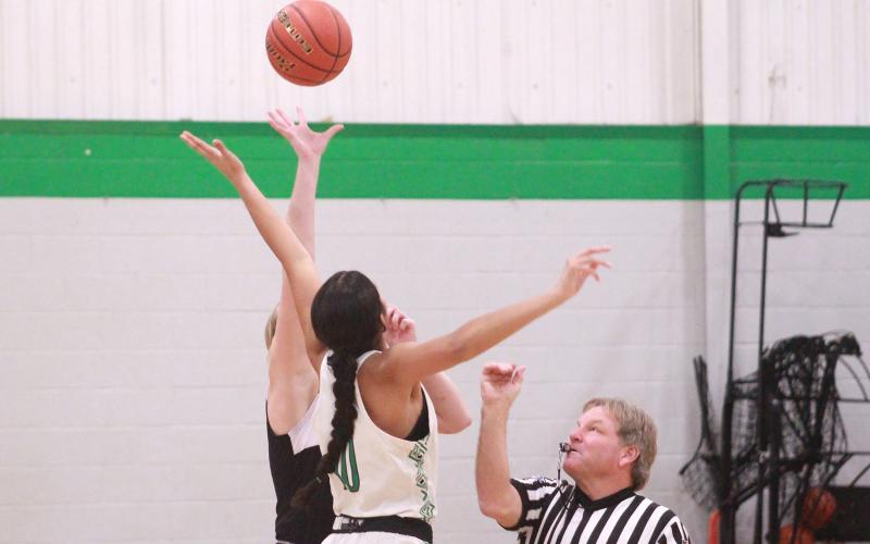 (TC GORDON | THE GRAHAM LEADER) Newcastle’s Mya Cabrera jumps for the tip-off during her team’s district match-up against No. 1 ranked Throckmorton this past Tuesday, Jan. 2. The Ladycats went on to win big over the Lady Hounds 54-30.