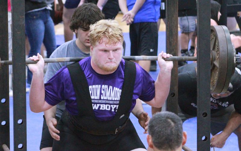 (TC GORDON | THE GRAHAM LEADER) Senior Kaleb Crawford executes his squat lift during the Graham Steers’ first powerlifting event of the season Thursday, Jan. 11 in Weatherford. The varsity Steers took third place in the four-team competition.
