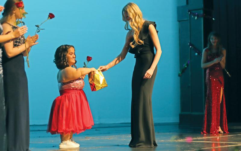 (THOMAS WALLNER | THE GRAHAM LEADER) Katie Parker is presented an award for the contestant who showed the most bravery at the All-American Girl Pageant held Saturday, Feb. 24.