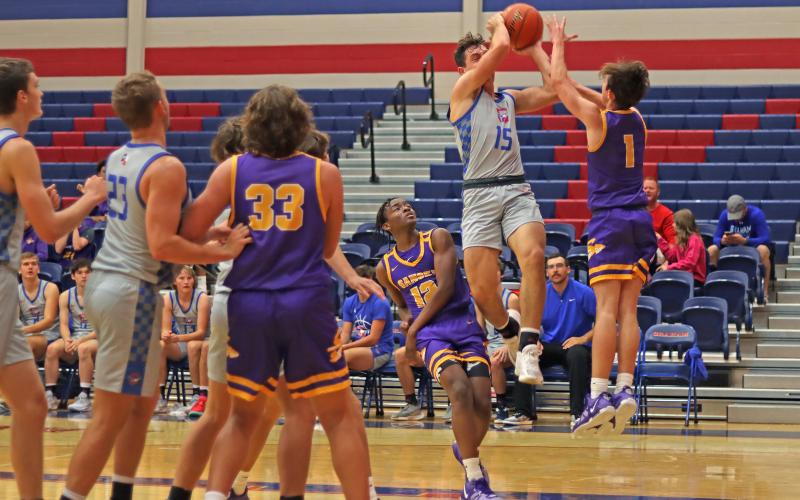 (THOMAS WALLNER | THE GRAHAM LEADER) Graham’s Ty Thompson (15) leaps into the air to attempt a contested layup during the team’s 60-58 loss to Sanger last Tuesday, Nov. 21.