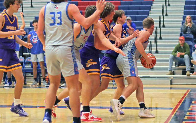 (THOMAS WALLNER | THE GRAHAM LEADER) Samuel Rodgers tries to back the ball out while being double-teamed by Sanger defenders during Graham’s match-up Tuesday, Nov. 21 with the Indians. The Steers played a close game but couldn’t get the tying shot to fall as they lost 60-58.