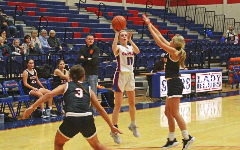 (TC GORDON | THE GRAHAM LEADER) Graham’s Maddie Franklin attempts a 3-point shot from deep during the team’s game Friday, Nov. 17 against Nocona. The Lady Blues lost to the Lady Indians, who are ranked No. 3 in Class 2A.