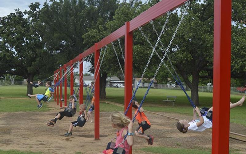 Kids at Crestview Elementary swing on 16 sets of swings recently added to the playground. The project was funded by the school’s PTO.