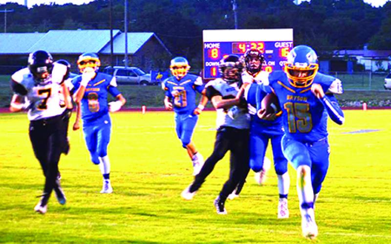Bryson quarterback Brayden Houser (15) rumbled into the endzone for the game-tying touchdown in the opening quarter. Bryson would go on to out-score Woodson 61-16 in the homecoming event.  Leader photo by Monica Buchanan