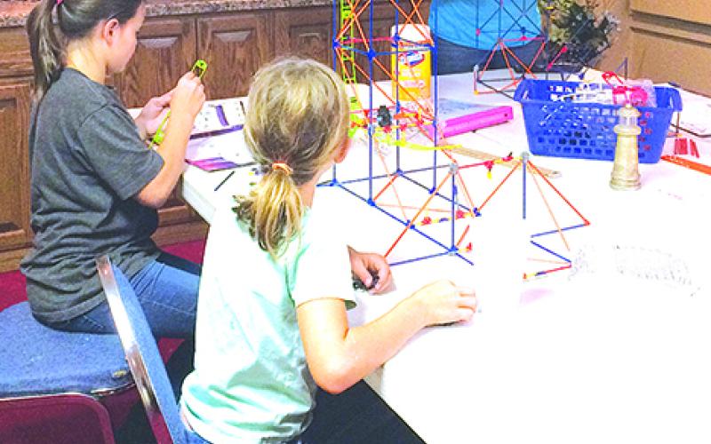 Pictured from left to right are Lizzy Tenut, Hannah Tenut and Abby Tenut who are constructing a rollercoaster from K’NEX as part of the Graham Robotics Academy program. Courtesy photo