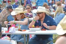 (THE GRAHAM LEADER | ARCHIVE PHOTO) Visitors to the Crawfish and Cannons event in 2023 chow down on some crawfish available at the event. The event this year will be held Saturday, April 13 at Fort Belknap.