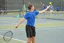 (FILE PHOTO | THE GRAHAM LEADER) Graham’s Scott Grimes tosses the ball into the air as he prepares to serve during one of the tennis team’s matches earlier this season. Grimes won his singles match and was part of a winning doubles pairing Tuesday, Sept. 19 in Graham’s 16-3 win over Bowie High.