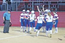(MIKE WILLIAMS | THE GRAHAM LEADER) The Lady Blues celebrate a three-run home run hit by Meagan Brooks (3) during the bottom of the third inning of their 4-0 win Tuesday, March 7 over Bridgeport.
