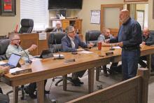 (TC GORDON | THE GRAHAM LEADER) Joe Gambill (right) of Strategic Economic Efforts, presents to the Young County Commissioners Court how his firm will help write the grant application for a mobile mental health unit for the county at a specially called meeting Friday, Feb. 2. 