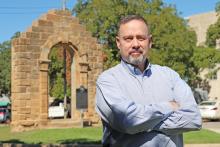 (THOMAS WALLNER | THE GRAHAM LEADER) Phillip Gregory poses in front of the downtown archway Friday, Oct. 6. Gregory was appointed to the position of 90th Judicial District Judge by Gov. Greg Abbott. He will serve the unexpired term of former judge Stephen Bristow, who retired Saturday, Sept. 30.