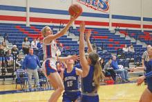 (TC GORDON | THE GRAHAM LEADER) Senior guard Maddie Franklin attempts a layup over two Childress defenders during the Lady Blues’ 47-21 loss Thursday, Dec. 28 to the Lady Bobcats.