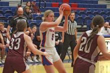 (TC GORDON | THE GRAHAM LEADER) Fayth Bryer (5) looks for an open teammate to pass to during Graham’s 40-39 win Saturday, Dec. 16 over Seymour. The Lady Blues held on for a big win over an opponent they’d already faced once before this season.
