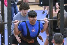 (TC GORDON | THE GRAHAM LEADER) Andrew Ramirez, of the Steers powerlifting team, goes down for his squat lift during the team’s competition against three other teams at Weatherford last Thursday, Jan. 11. The Steers finished in third place in the event.