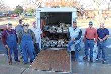 (THOMAS WALLNER | THE GRAHAM LEADER) Members of the Young County Masonic Lodge #485 pose the morning of Friday, Dec. 22 next to a trailer with 164 turkeys cooked overnight by the group. A majority of the turkeys cooked were donated to those less fortunate in the community.