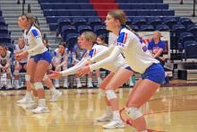 (FILE PHOTO | THE GRAHAM LEADER) Sophomore Tara Dawson (front), junior Braylee Mayes (middle) and senior Olga Morales (back) prepare to receive a serve during one of Graham’s matches this season. On Tuesday, Sept. 19, the Lady Blues swept the Cooper Lady Cougars in Abilene 3-0.