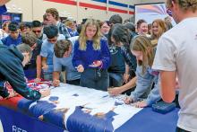 (NCTC | CONTRIBUTED PHOTO) Students at Graham High School sign a banner for the Red River Promise program with North Central Texas College. The last-dollar scholarship program has been used by GHS students since August 2022 at NCTC.
