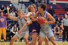 (THOMAS WALLNER | THE GRAHAM LEADER) Keion Shead (with ball) backs down a Sanger defender while Riley Lanham (2) fights for positioning during Graham’s game against the Indians last Tuesday, Nov. 21. The Steers fought hard but fell to the visiting Indians 60-58.