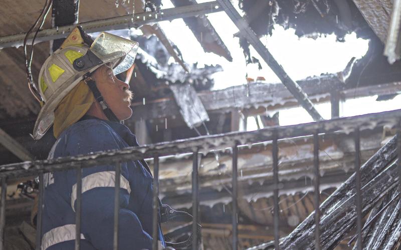 (ARCHIVE PHOTO | THE GRAHAM LEADER) Graham Fire Rescue Chief Dennie Covey works with firefighters Nov. 14, 2014 to extinguish a blaze at Young County Title on the north side of Graham’s downtown square.