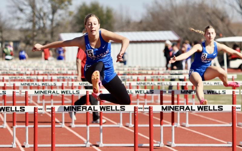 (ARCHIVE PHOTO | THE GRAHAM LEADER) Braylee Mayes competes in a hurdles event during the Mineral Well Ram Relays to kick off the season. The team competed Thursday, March 6in the Legan Friends and Family Invitational Meet in Springtown.
