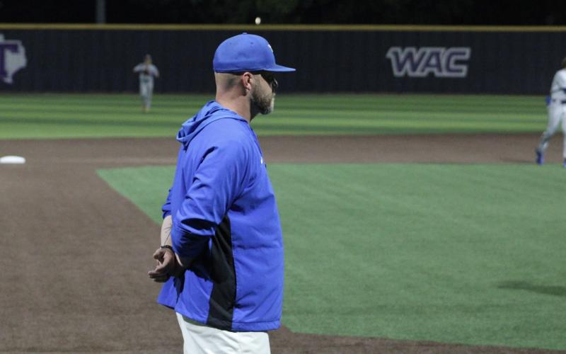 (ALEX HAVARDANSKY | THE GRAHAM LEADER) Head coach Allen McGee stands at third directing his players Thursday, May 22. McGee expressed pride in his team despite a 7-0 loss to Brock.  