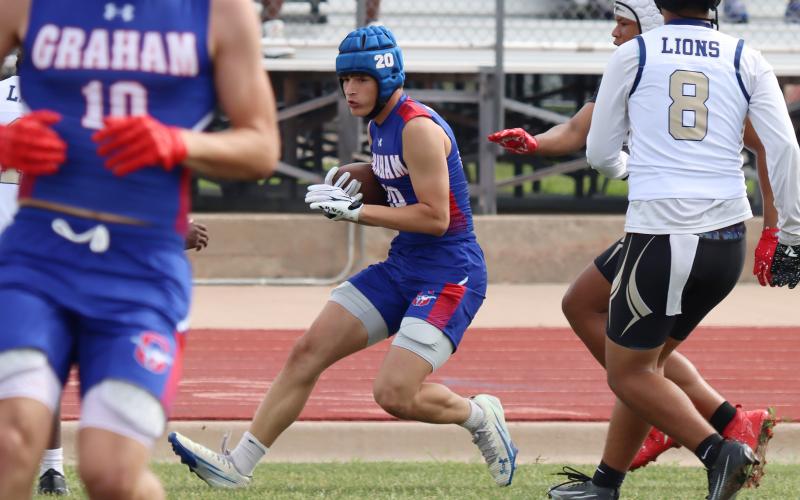 (THOMAS WALLNER | THE GRAHAM LEADER) Austin Kilpatrick dodges the Dallas Life Oak Cliff defense during the Mineral Wells State Qualifying Tournament for 7on7 held Friday, May 22. During the tournament the Steers advanced to state which will be held in June.